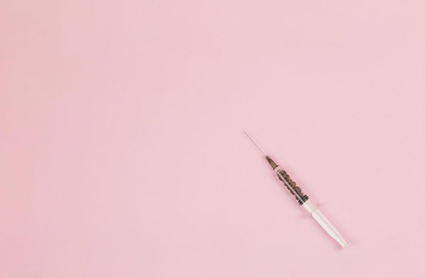 Syringe on Pink Background