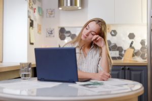Exhausted Woman at Computer Showing Fatigue from Anxiety